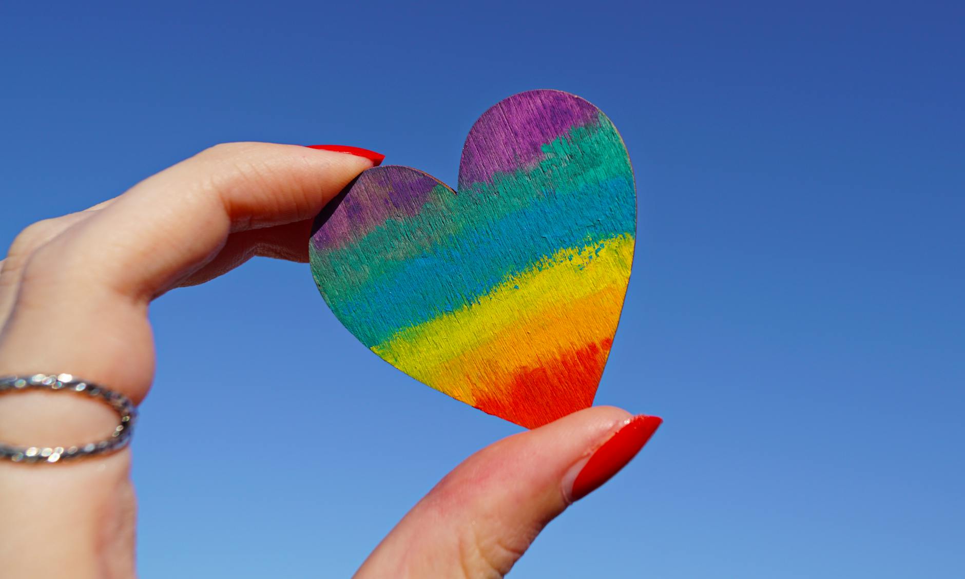 person holding multicolored heart decor